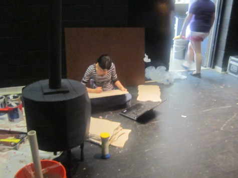 Backstage crew helps create scenery for the stage