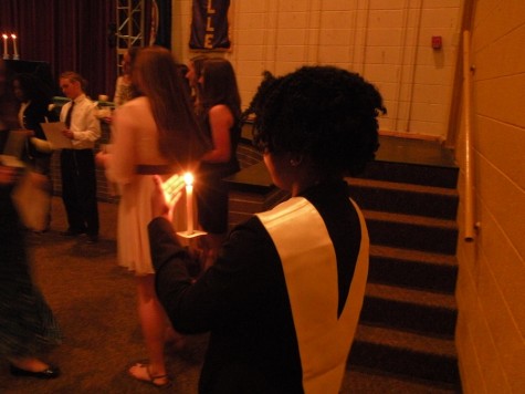NHS historian Mbiye Kasonga carries the mother candle for the ceremony