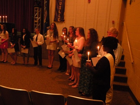 Inductees light each others candles 