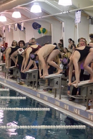 Menchville swimmers line up and get in starting position to kick off the swim meet.