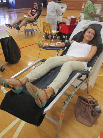 Senior Jenny Loya gives blood happily in the Key Club's Red Cross Blood Drive.