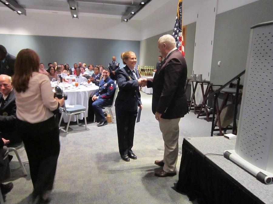 Cadet Taylor Pobiak receives an award and scholarship from visiting veterans
