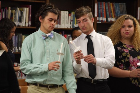 Inductees Ricky Marstellar and Robby Mcfaddin light their candles for induction. 