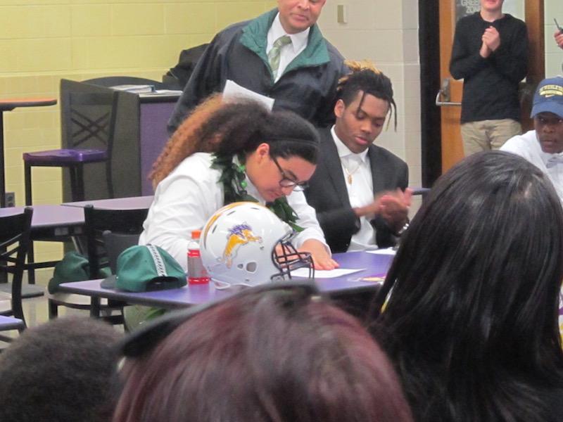 Kalepo Naotola signs his letter of intent to play collegiate football for Hawaii University.