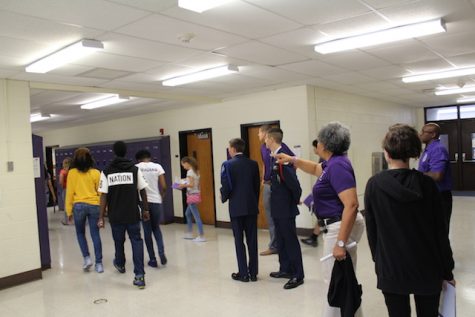 Menchville's staff direct students into the auditorium. 