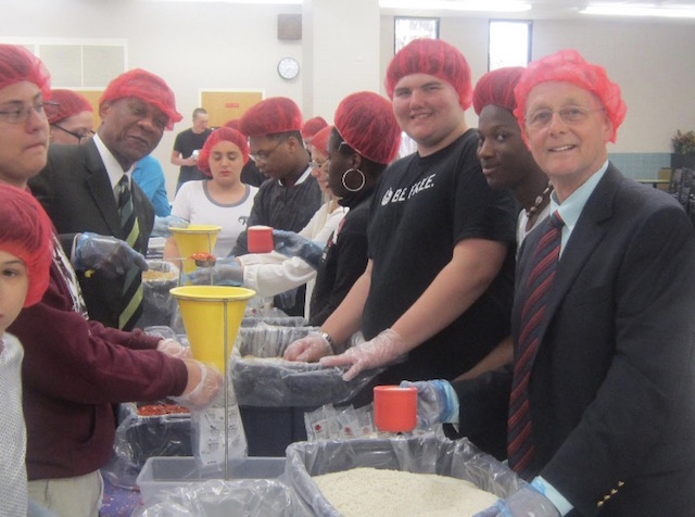 Principal Bobby Surry and Vice Principal Joseph Edwards help students package food