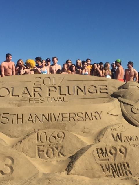 Its a little cold out here. The sky was clear but the temperature was 38 degrees when Menchville students plunged into the ocean to raise money for the Special Olympics.  Here students stand behind the 2017 Sand Sculpture.