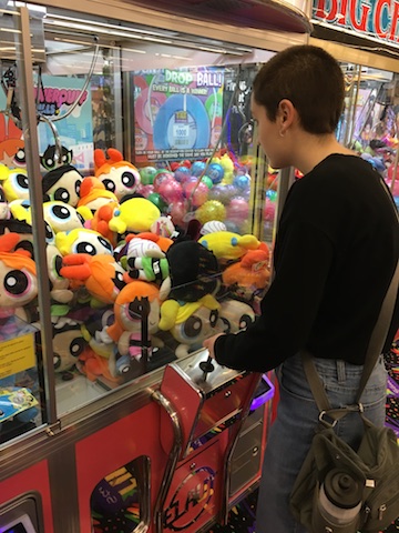 Junior Kelly Ritenour plays a claw machine game at the new TILT Studio.