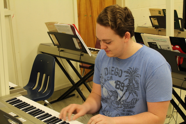Nicolas Gonzalez practices the keyboard during lunch. 
