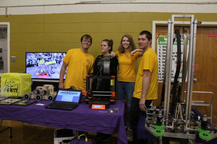 Triple Helix poses with the competition robot from last year- Genome Iota.