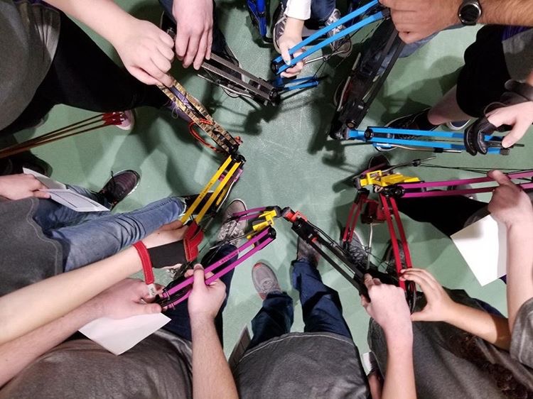 Archers form a star with their bows before the start of the tournament.