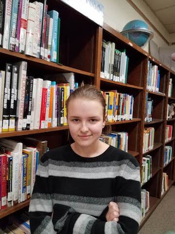 Hailey James poses for a portrait in the library. 