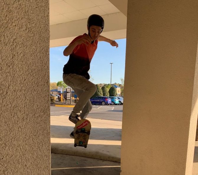 A skater does an ollie off of a ledge.  