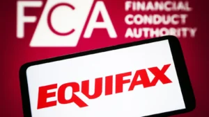 A consumer reviews a credit report and settlement paperwork on a laptop